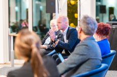 Man on stage speaking and gesturing