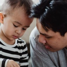 Young man and child playing together