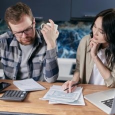 A couple looking worried while doing their budget