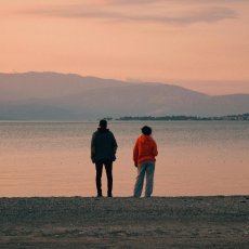 Two younger people looking out at the horizon