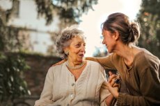 Older woman and younger woman about to hug