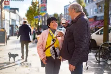 Older woman and man having a coffee in a shopping street