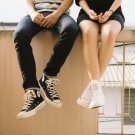 Shoes of two young people who appear to be sitting on a roof