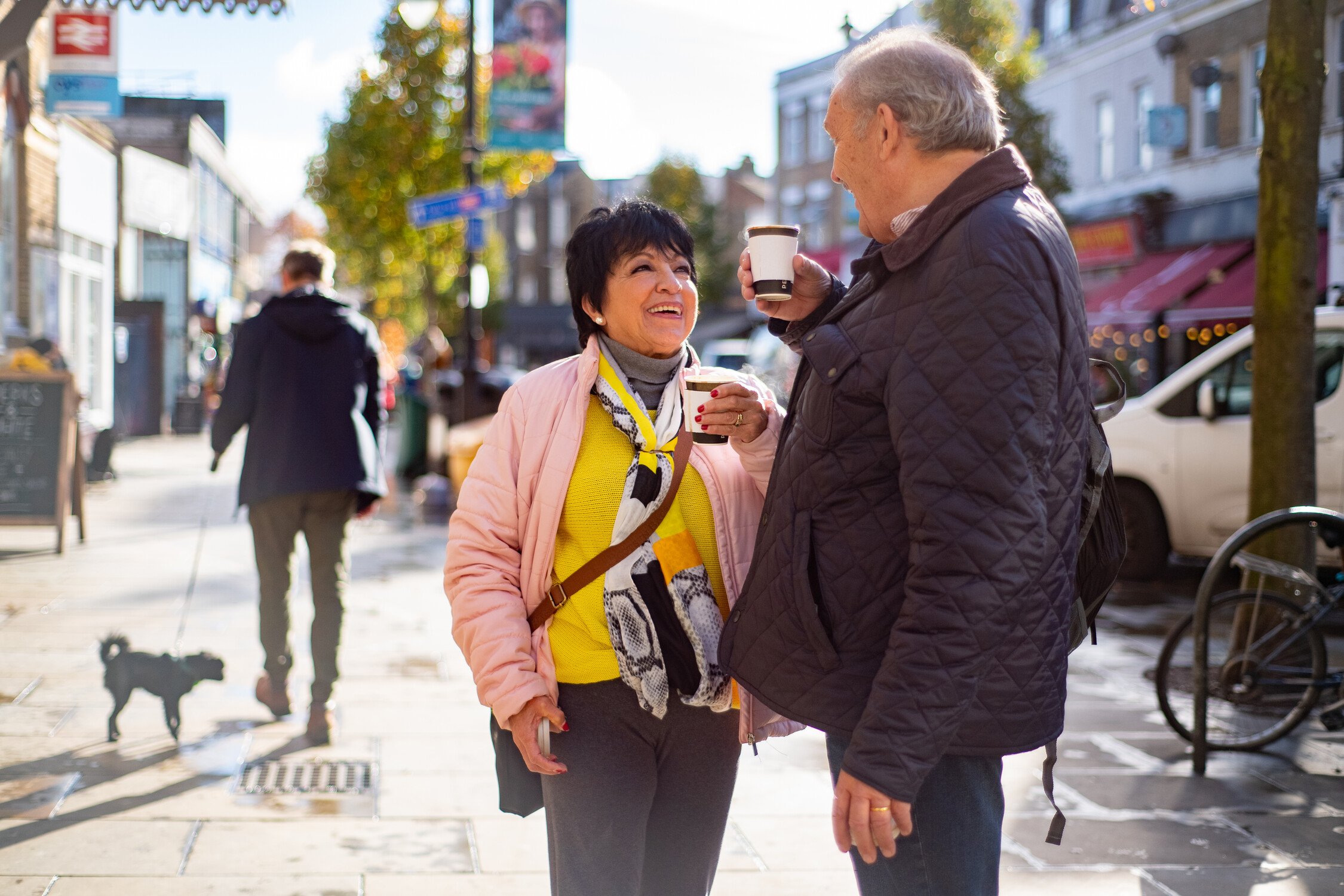 Two older people chatting in a commercial street