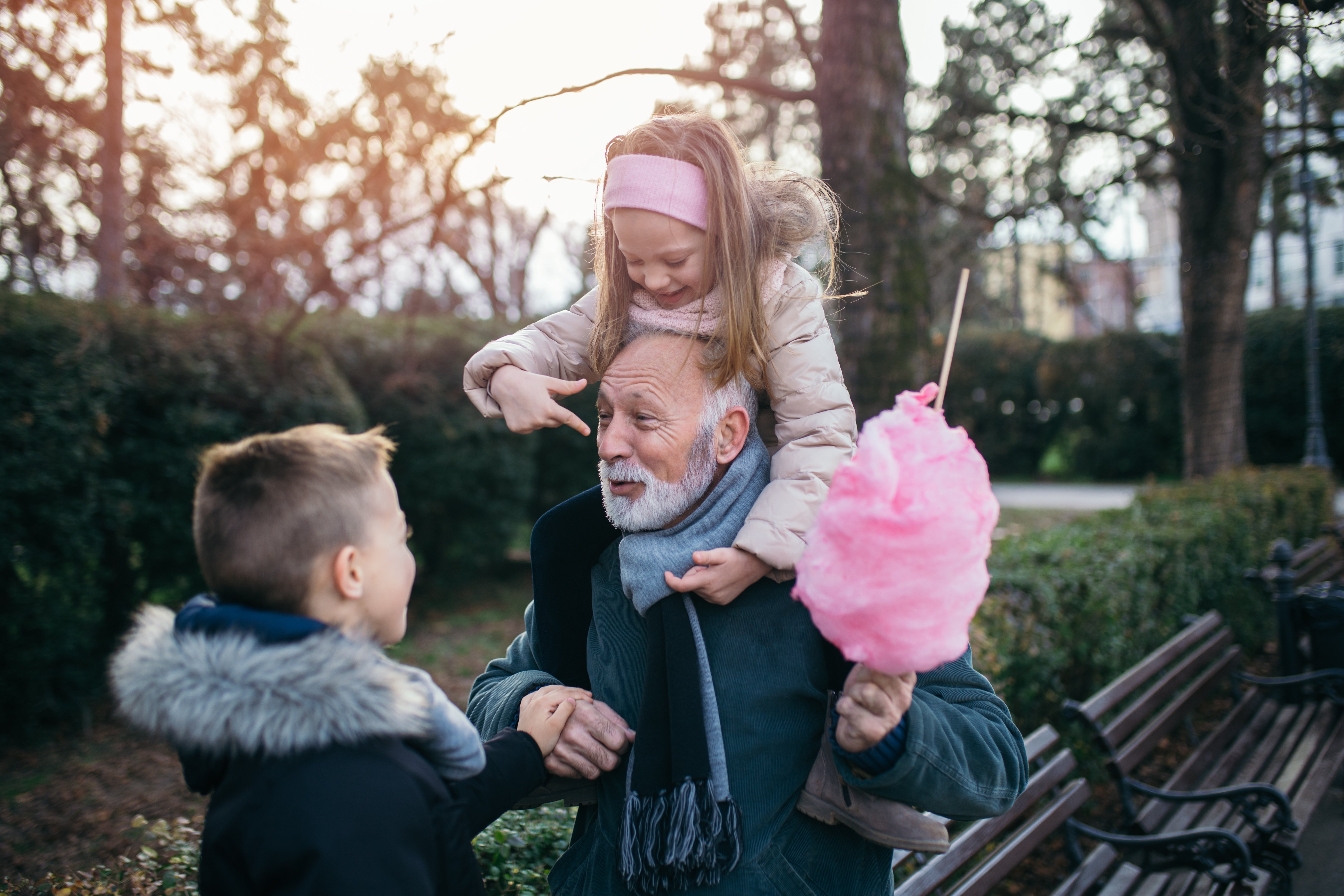 Two children and an older man playing together