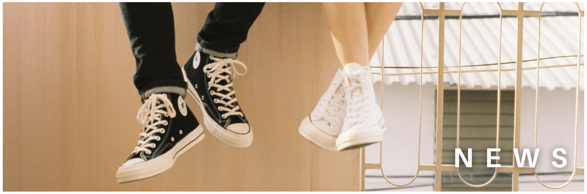 Shoes of two young people who appear to be sitting on a roof