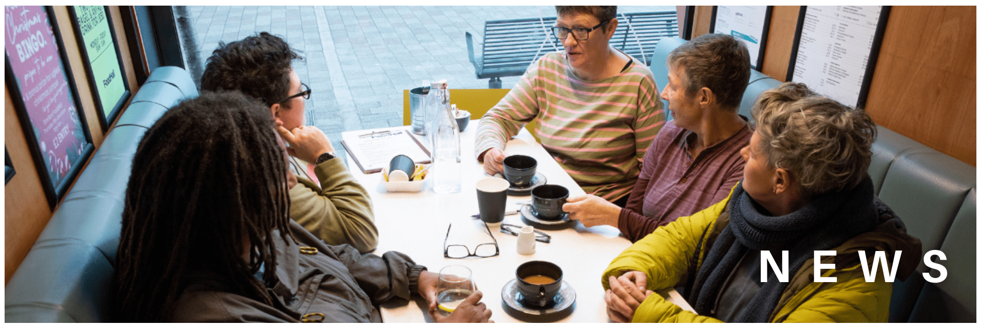 Group of older people at a cafe, in conversation