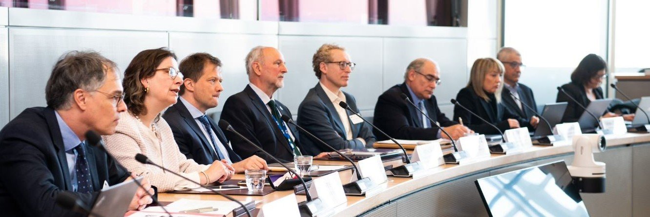 Experts around a table with microphones