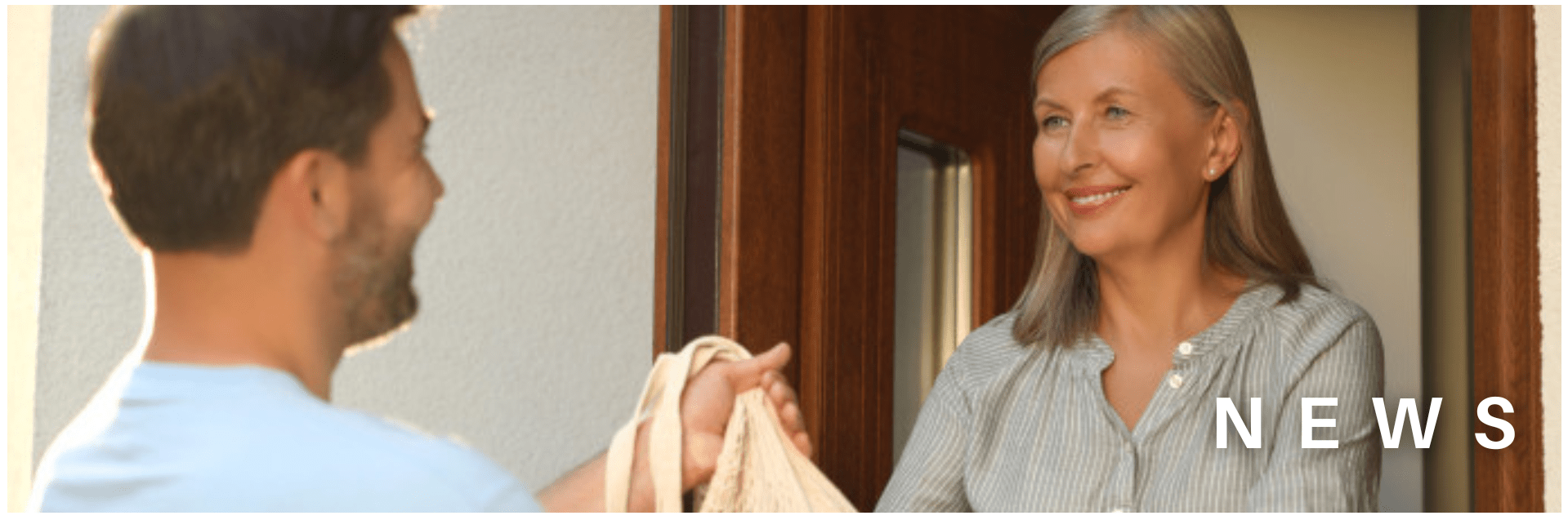 Older person receives a shopping bag at the door