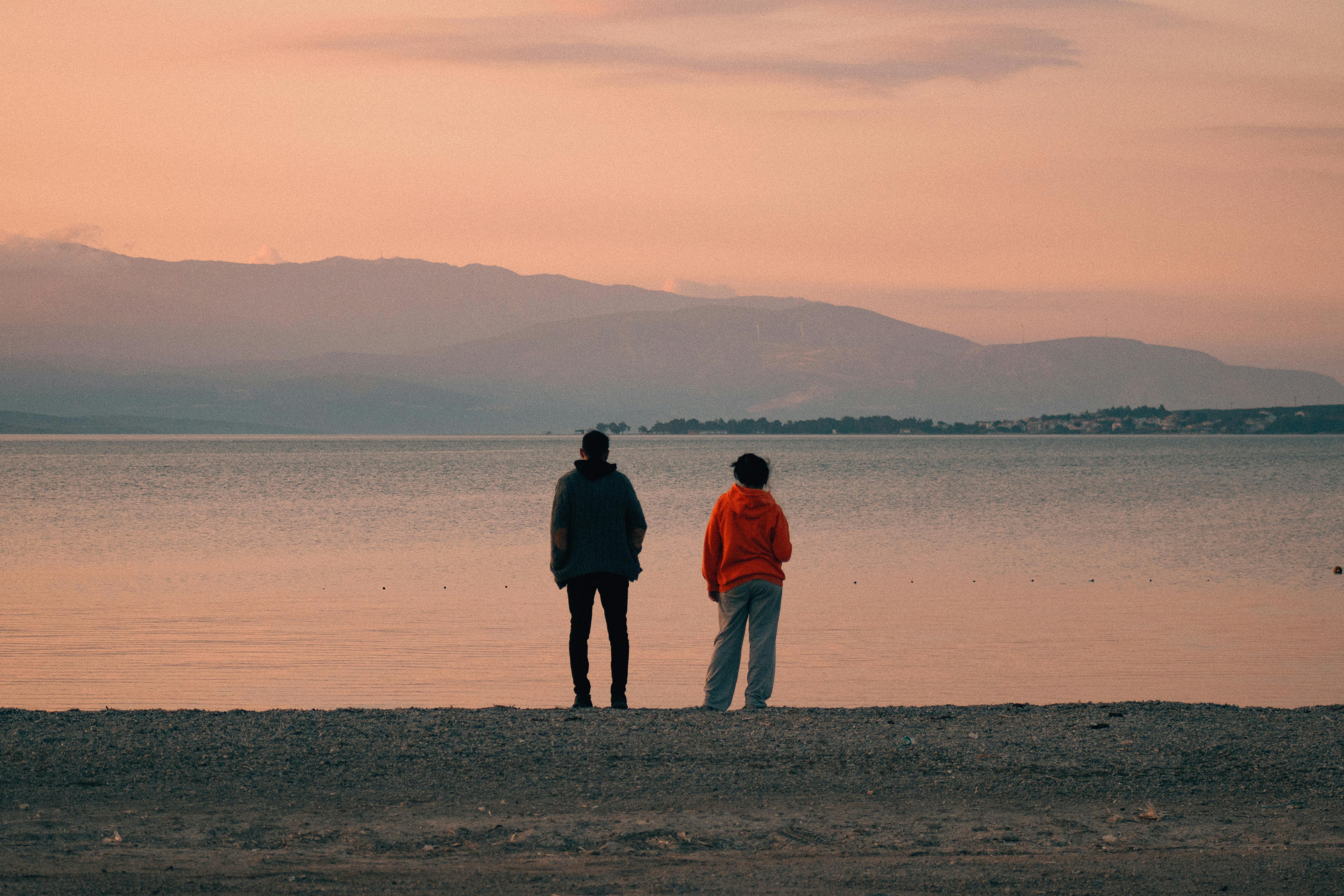 Two people looking out at the sea